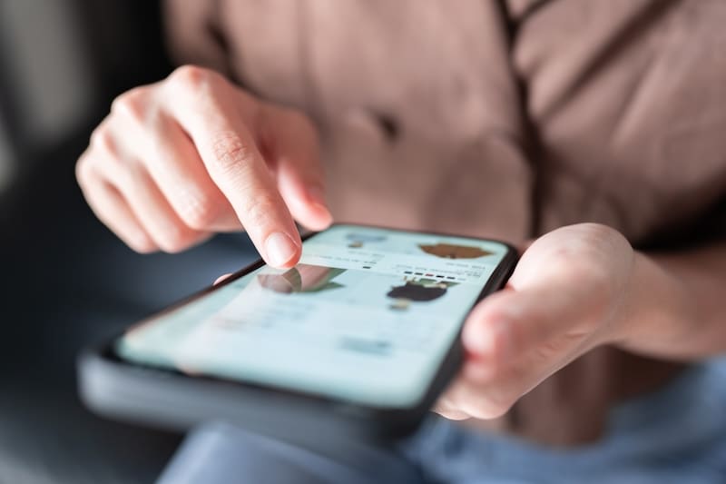 A person holding a phone and looking at a review request for products they ordered.