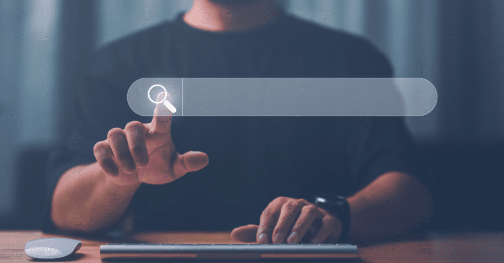 A person in a dark shirt using a futuristic touch-screen interface with an OfficialUSA.com opt out option, sitting at a desk with a keyboard and mouse in a dimly lit room.