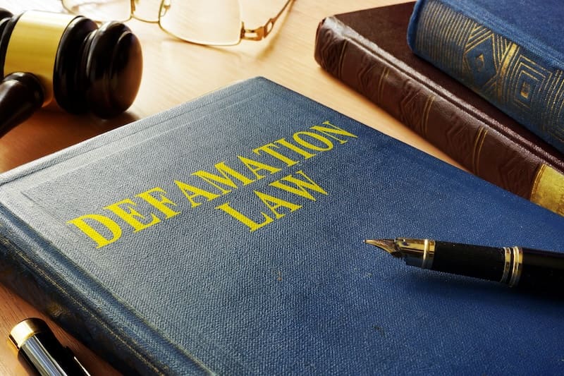 Defamation law on a table with a gavel.