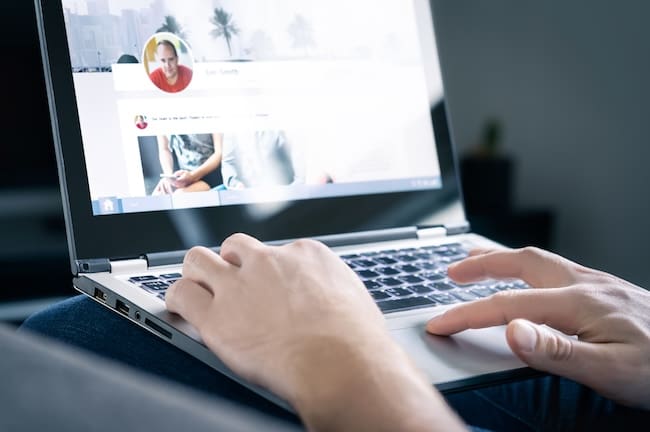 A person is using a laptop to bury negative search results about a facebook page.