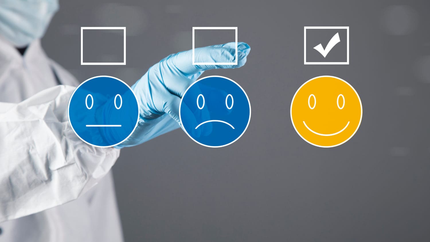 A doctor in a lab coat is pointing at a smiley face.