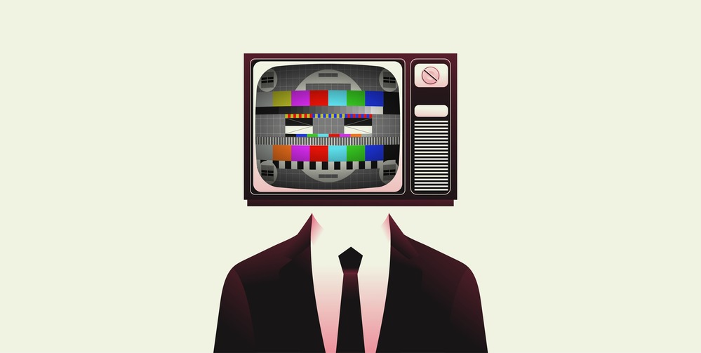 A man in a suit with a television on his head.