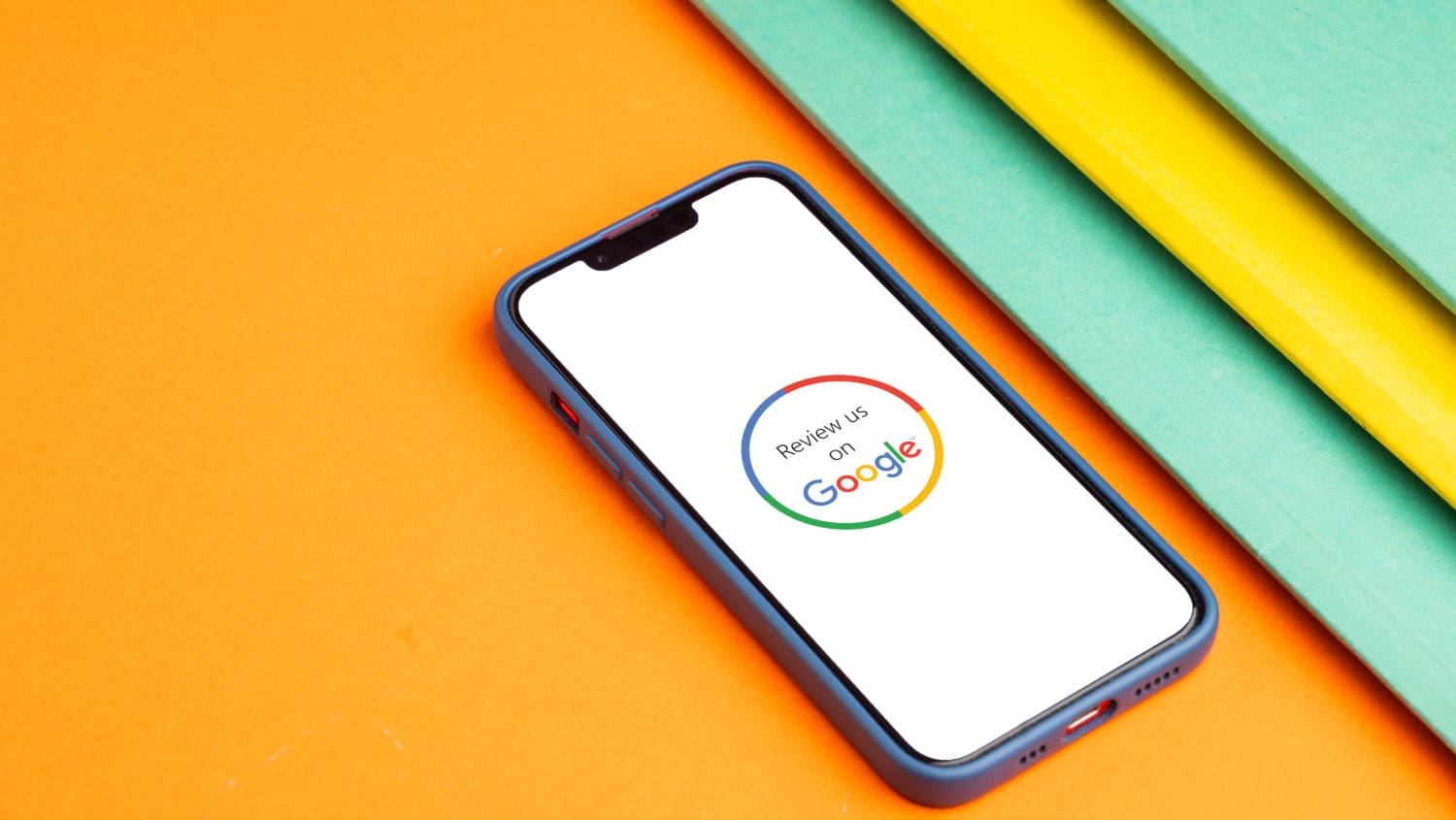 A phone with the google logo on top of a colorful background.