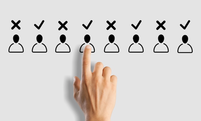 A hand is pointing at a group of people, illustrating company reputation management.