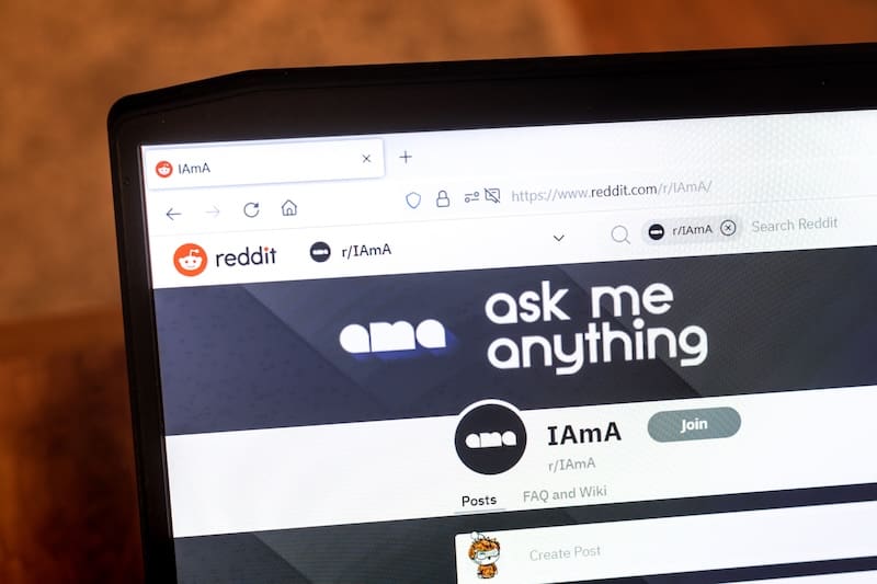 A laptop showing a Reddit Ask Me Anything page.