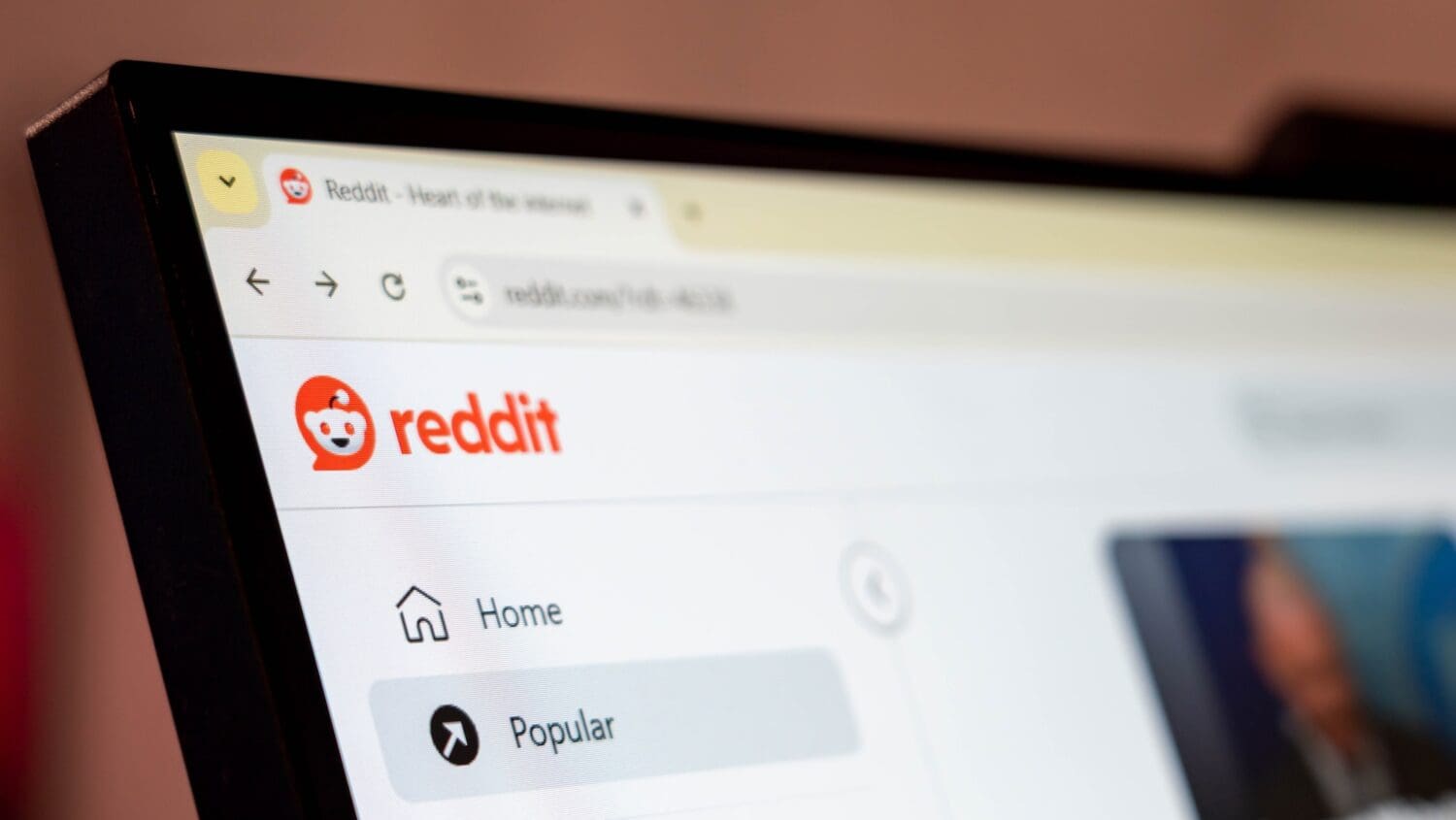 The top left of the Reddit home page shown on part of a laptop screen.