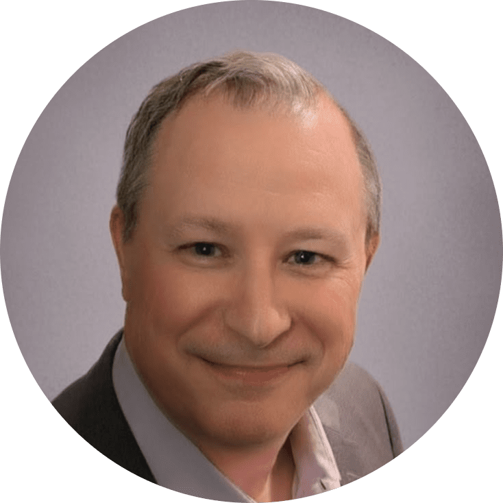 A middle-aged man with short gray hair smiles at the camera, wearing a gray suit jacket and light-colored shirt, representing his team against a plain light gray background.
