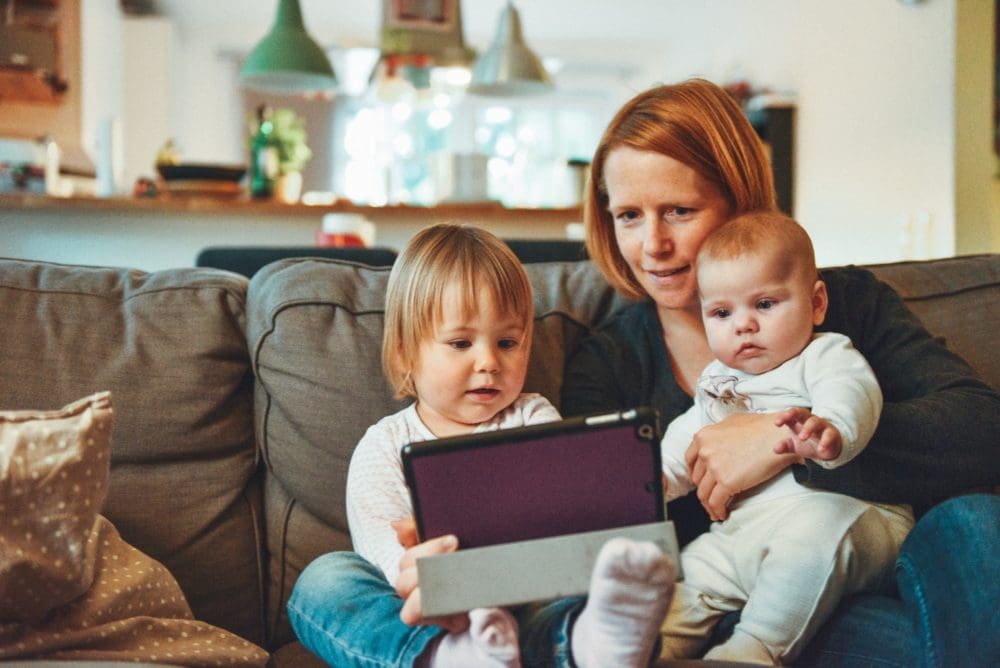 mother and children looking at ipad