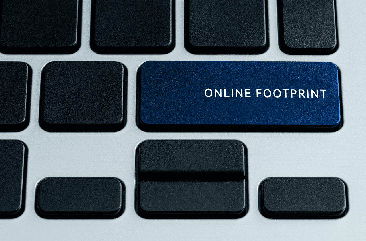 A computer keyboard with a blue key labeled "ONLINE FOOTPRINT" among black keys, symbolizing the concept of digital presence and internet activity.
