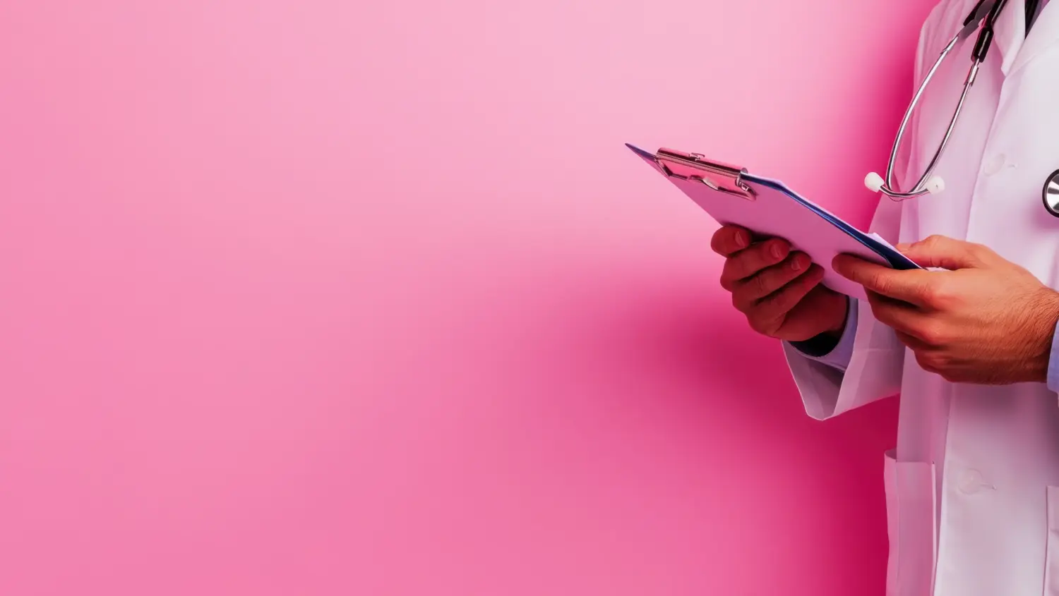 A doctor wearing a white coat and stethoscope holds a clipboard against a pink background.