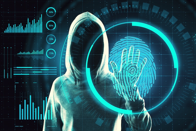 A man in a hoodie with a unique fingerprint on his hand demonstrates the importance of executive privacy.