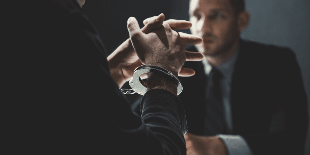 person in handcuff in meeting with lawyer