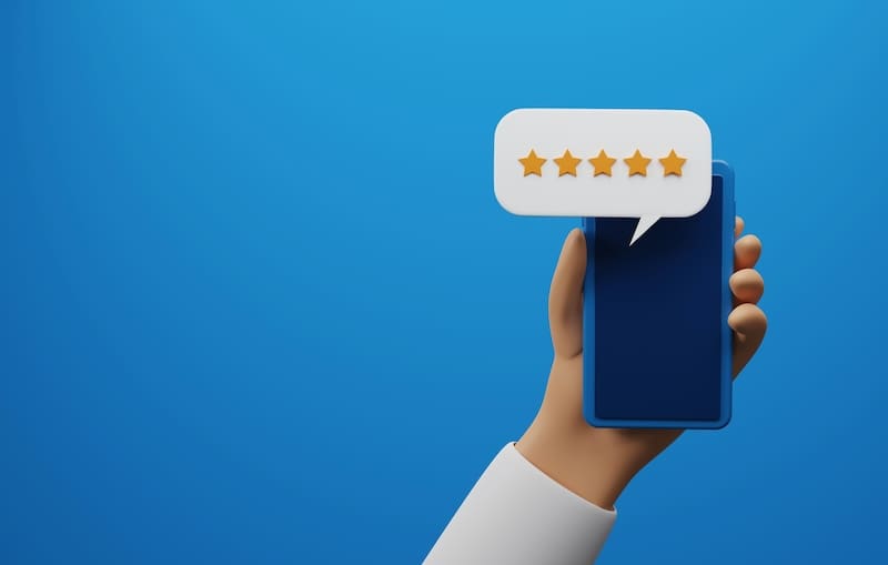 A hand holding a phone with a five star rating, representing personal online reputation management.