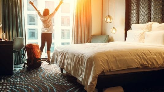 woman stretching in hotel room